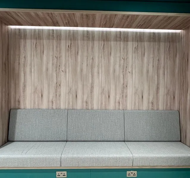 Veggpanel med sittebenk i kontorlokale.